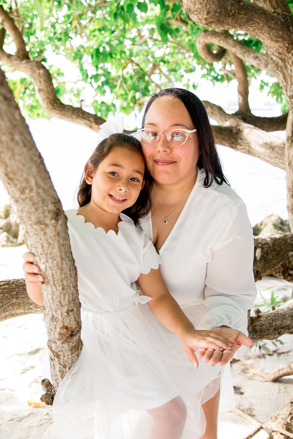 Mother kneeling down holding hands with young daughter