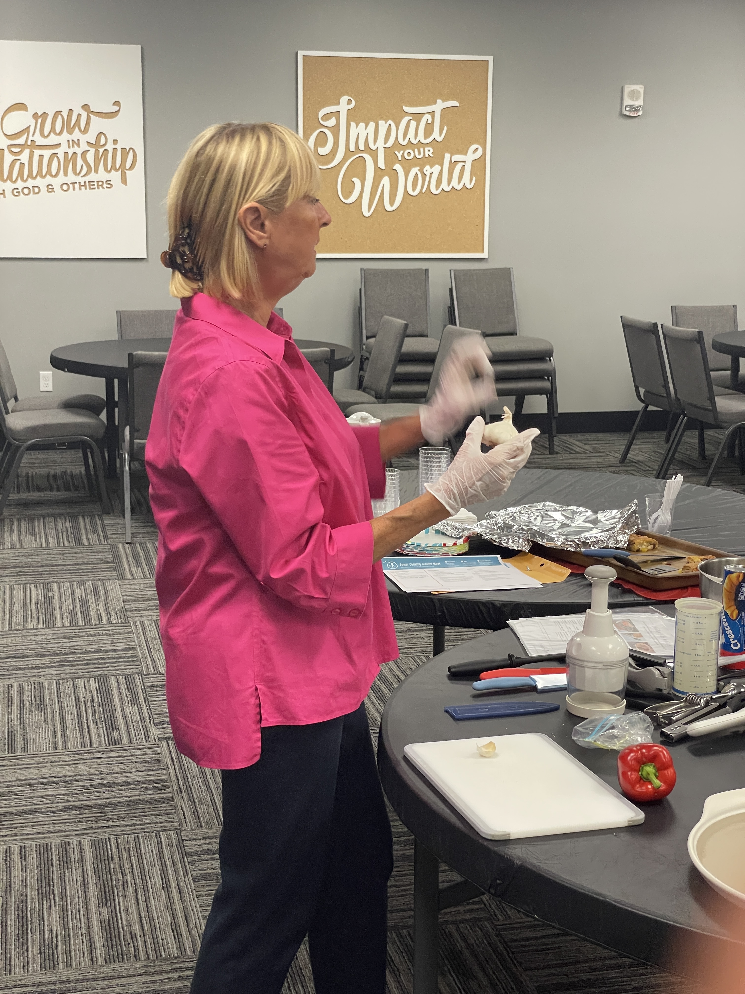 Teacher standing in front of class giving cooking lesson