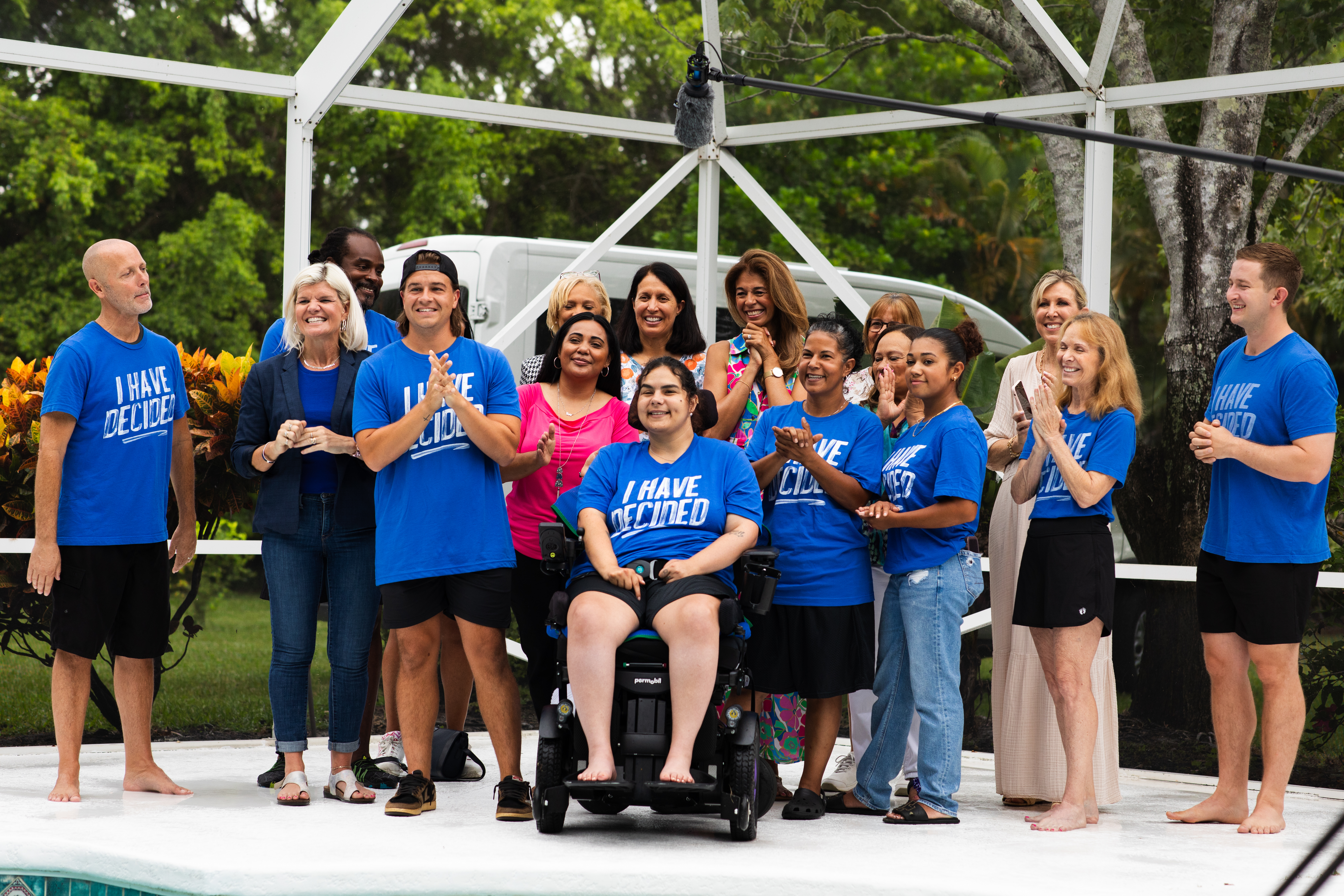 Group of happy people at a baptism in blue tee shirts