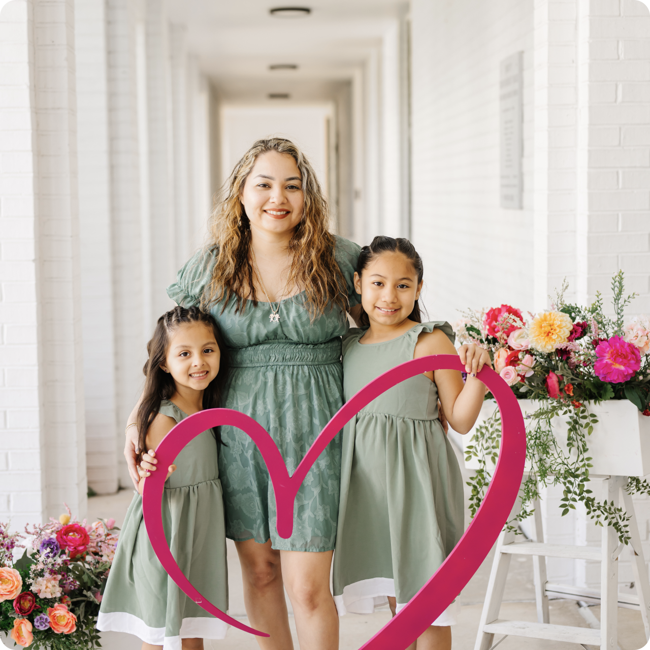 Woman having her nails done at a salon smiling.